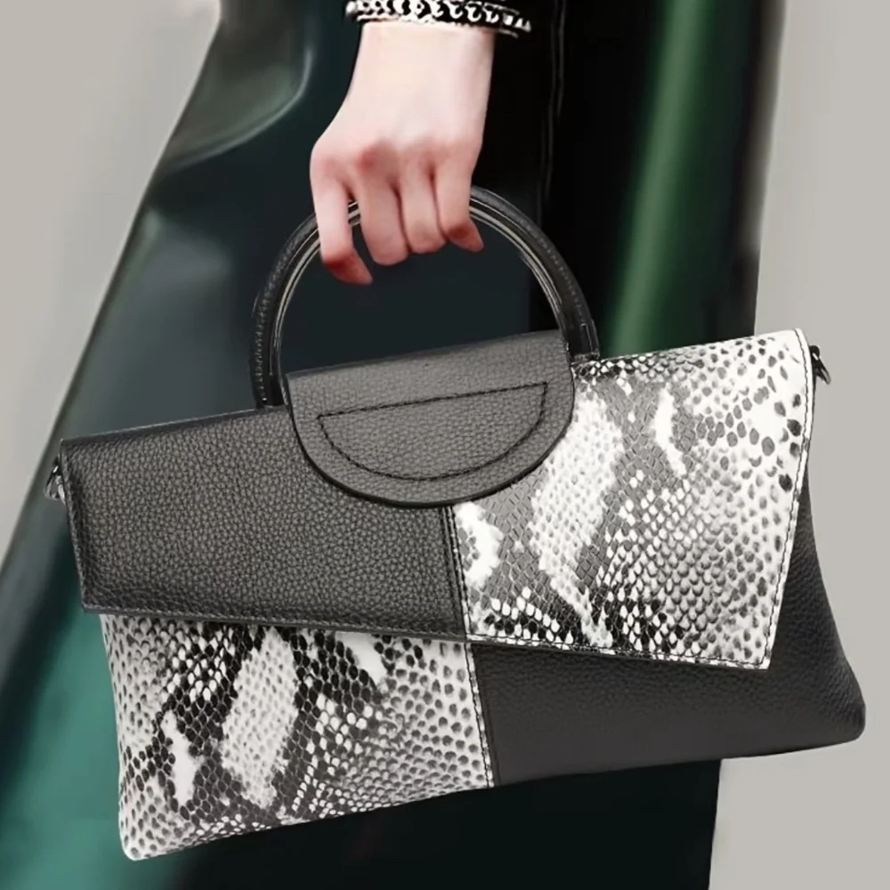 Luce black and white snakeskin clutch bag